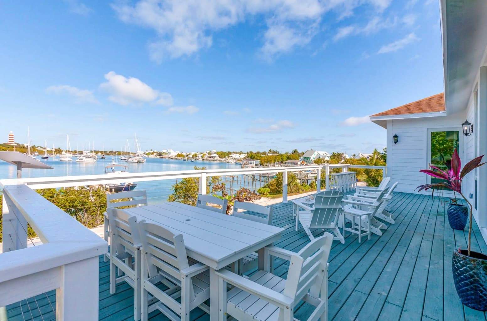 Waterfront deck with dining table overlooking harbour