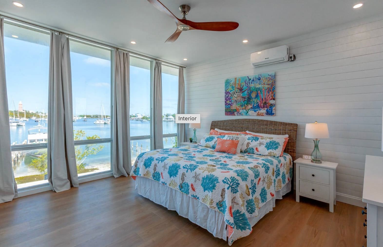 Master bedroom with harbour views and coral bedding
