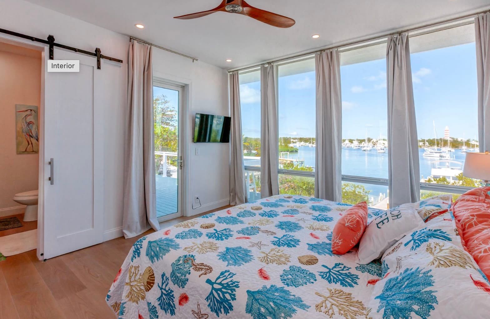 Master bedroom with floor-to-ceiling windows and harbour view