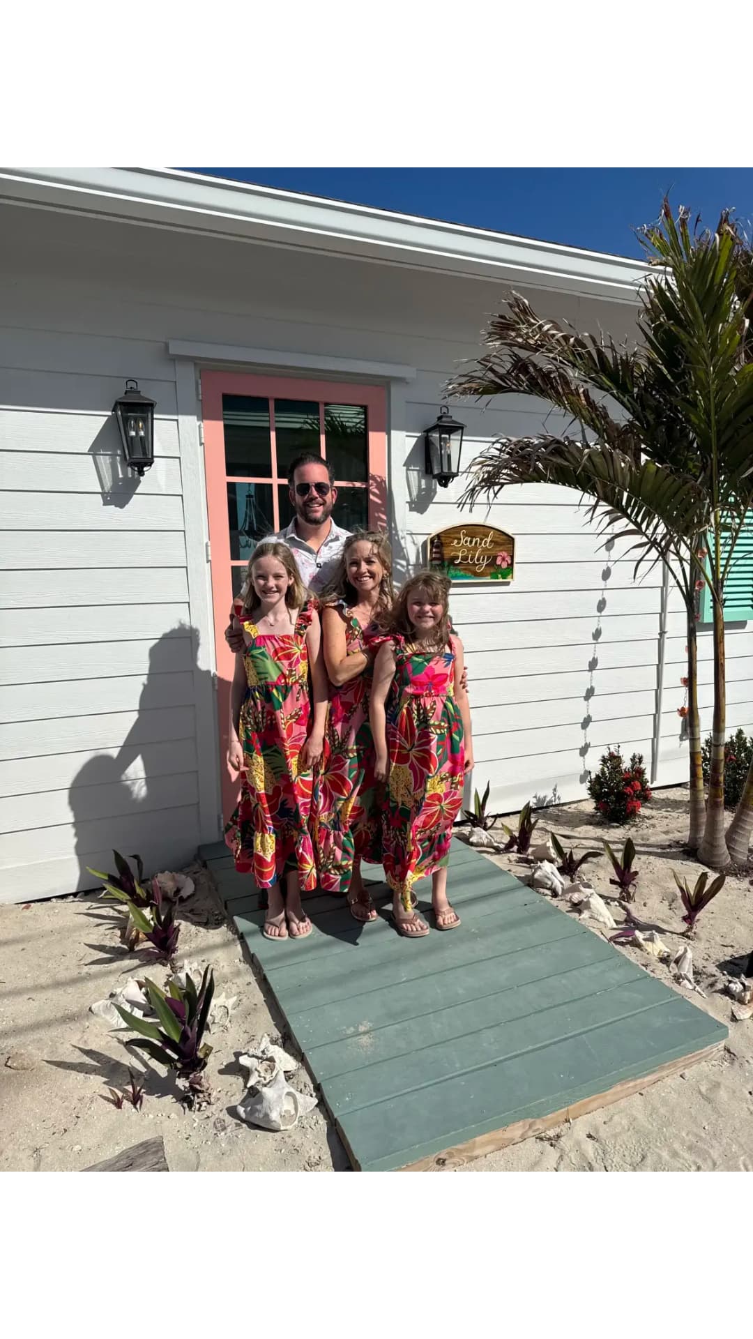 The SandLily Art family in front of their Hope Town home