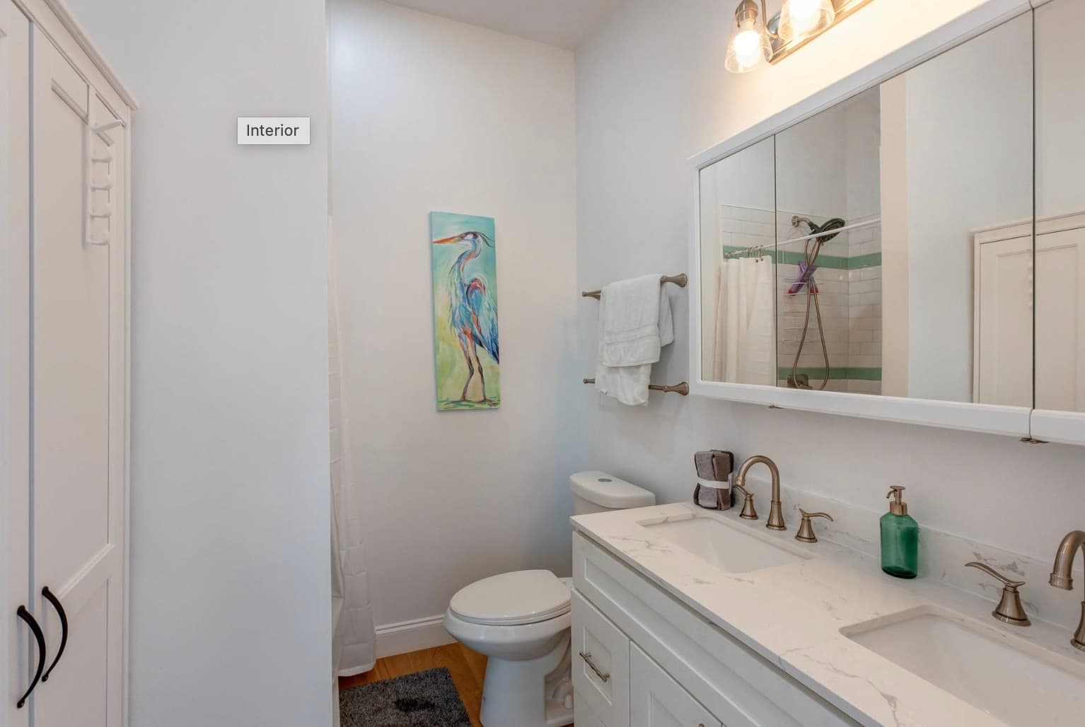 Master bathroom with heron painting and marble vanity