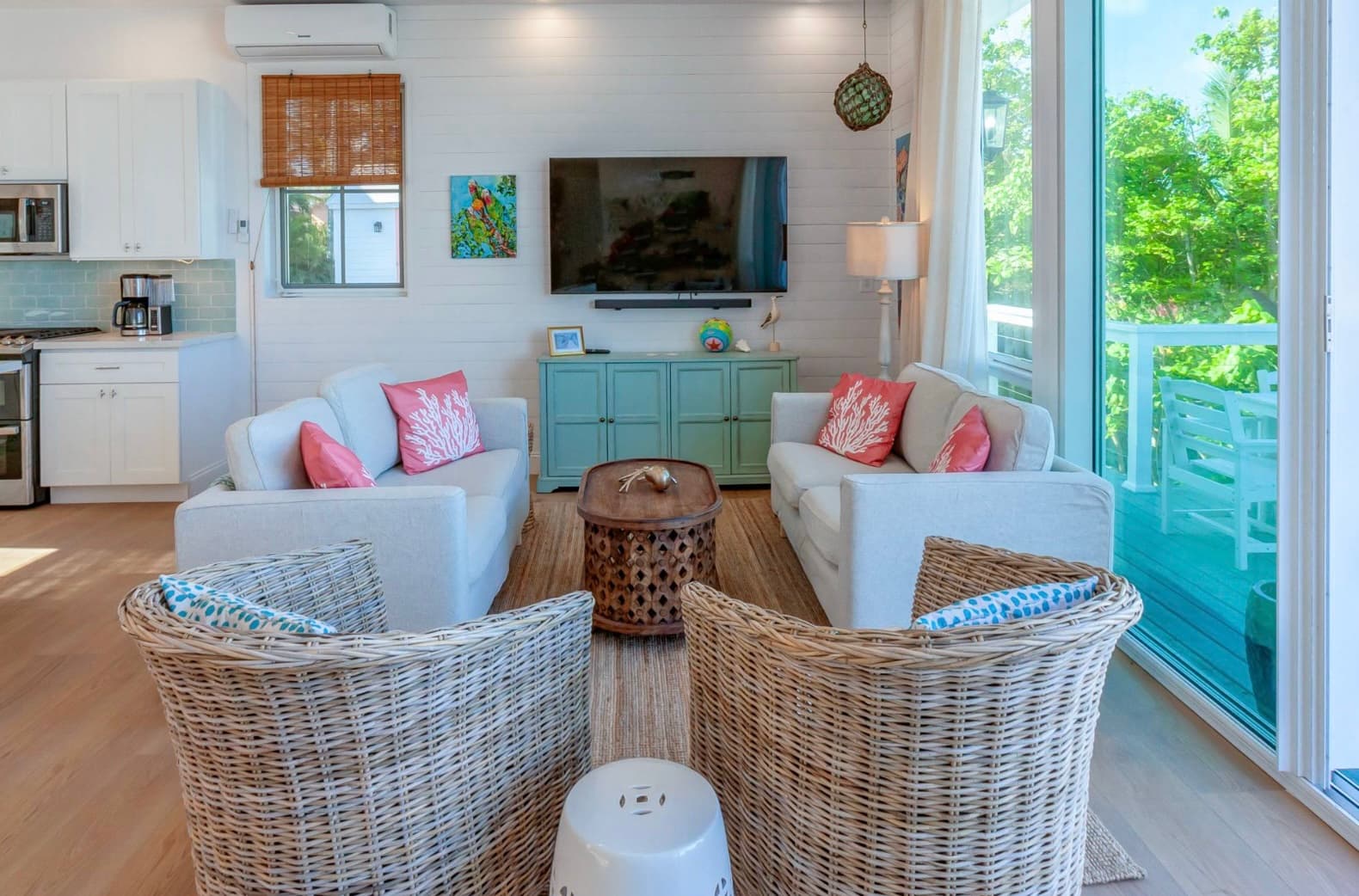 Living area with wicker seating and large windows