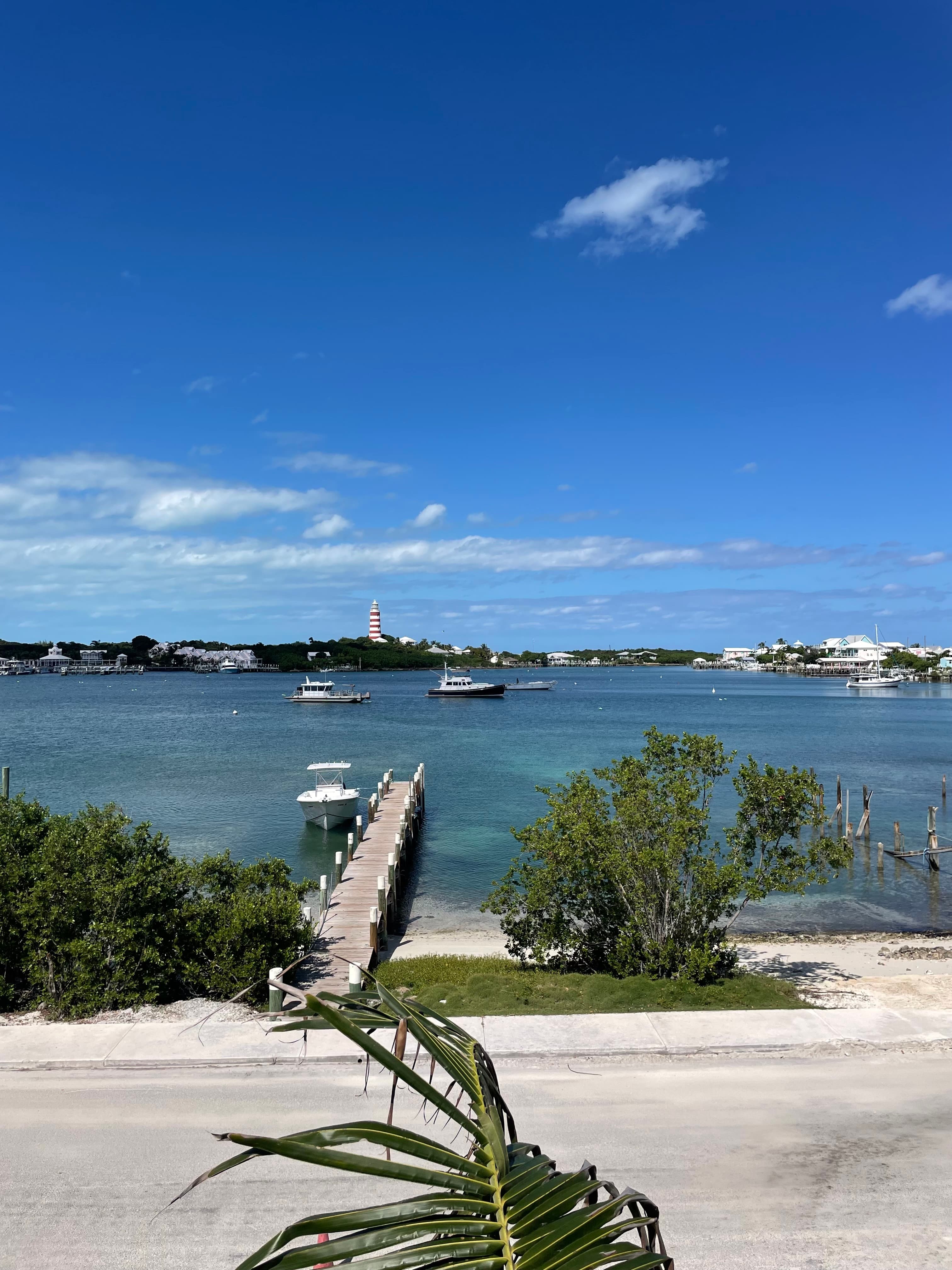 View from the dock with lighthouse and harbour boats